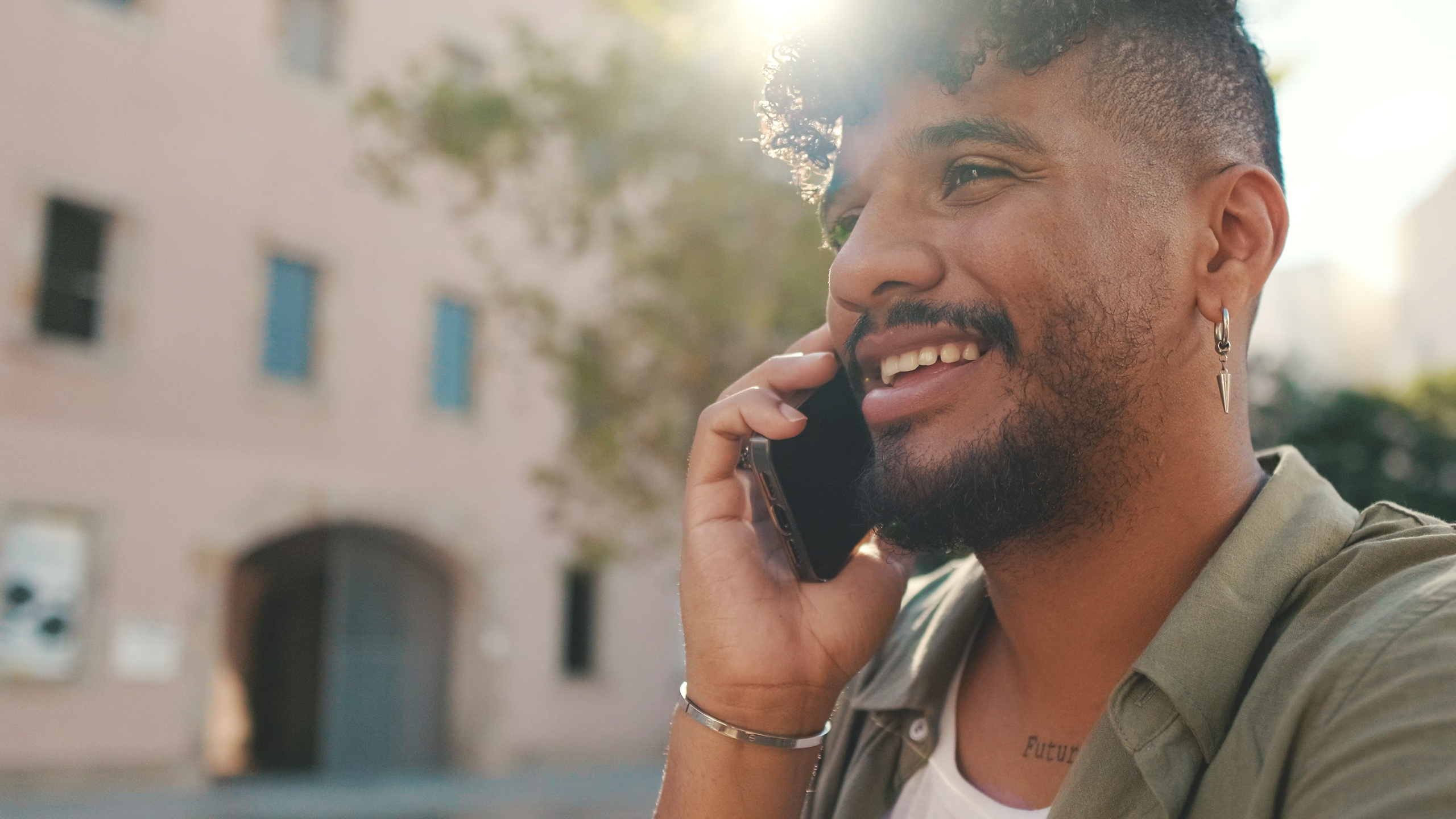 young-man-with-beard-talking-on-the-phone-while-s-2023-11-27-05-21-02-utc
