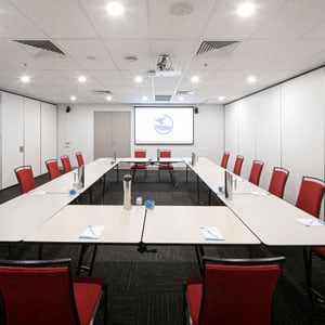 Medium side view shot of Greatorex Room at the Wesley Conference Centre, with Wesley Mission logo showing on digital screen