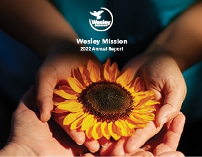 hands holding sunflower annual report
