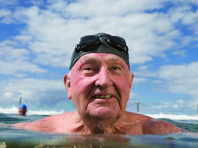 Senior man in infinity pool, close-up